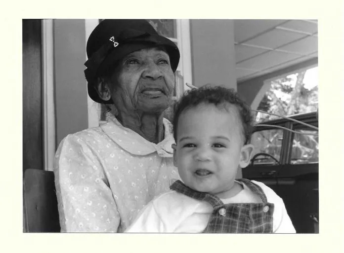 Miss-Iris-with-great-Granddaughter-Kamala-696x513.jpg.webp