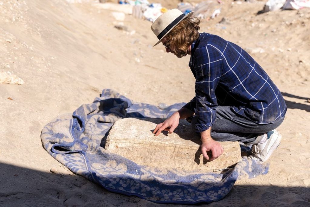 Ingo Strauch, a historian of ancient India, examines a third-century A.D. slab inscribed with Sanskrit. Roger Anis