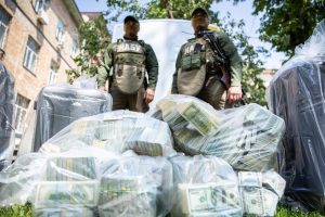 WATCH: Ukrainian Official Found Lying On A Bed Of Cash Amid Corruption Scandal 1